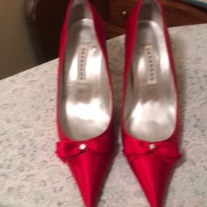 Red satin heels with bow detail